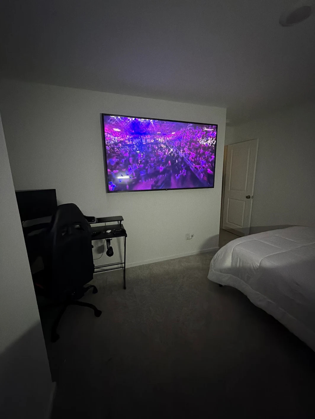 Bedroom TV mounted high for comfortable viewing from the bed