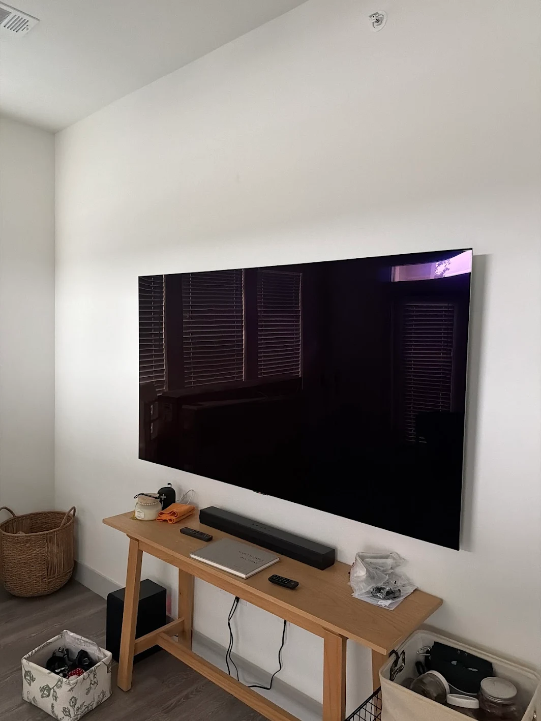 Clean wall-mounted TV installation with organized media console